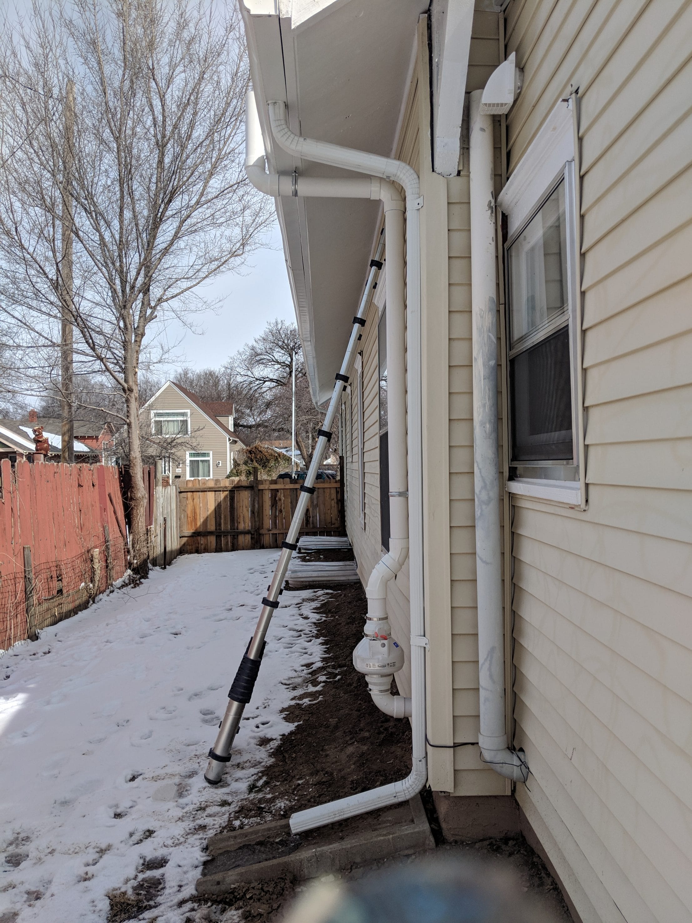 Radon system repair on house exterior

