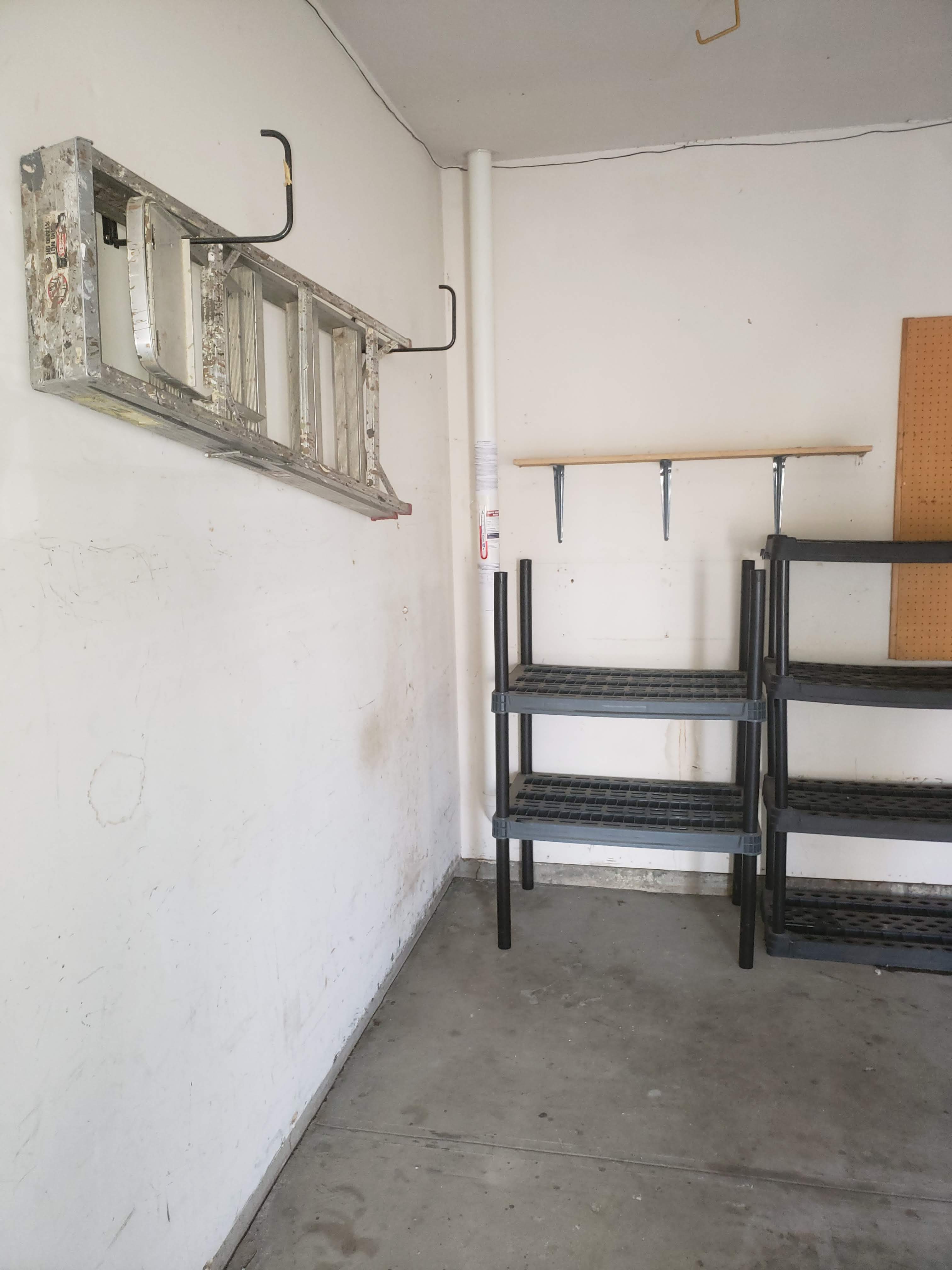 Empty Garage Corner with Radon Mitigation Pipe Installation
