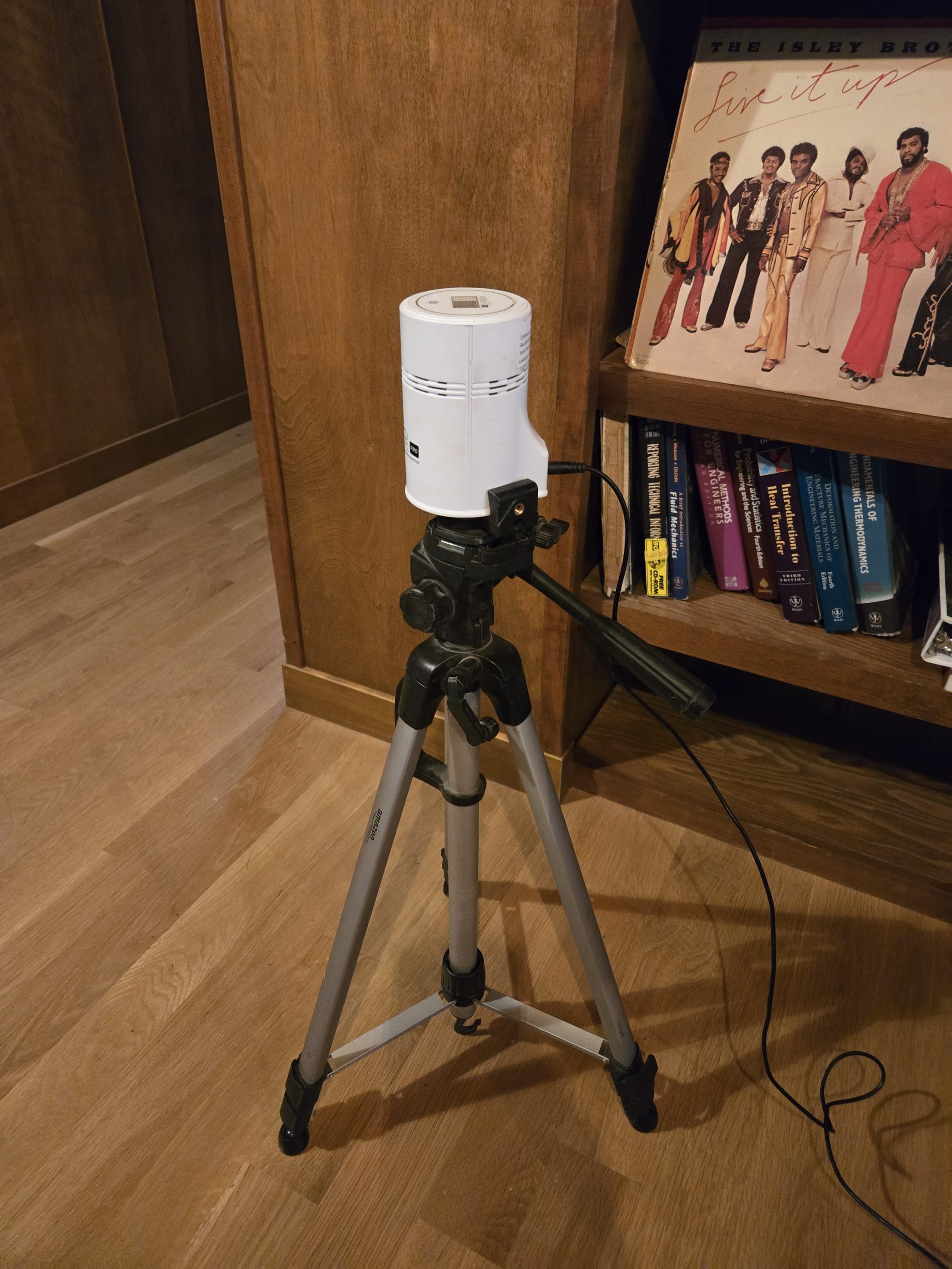 Radon measurement device on tripod in home setting
