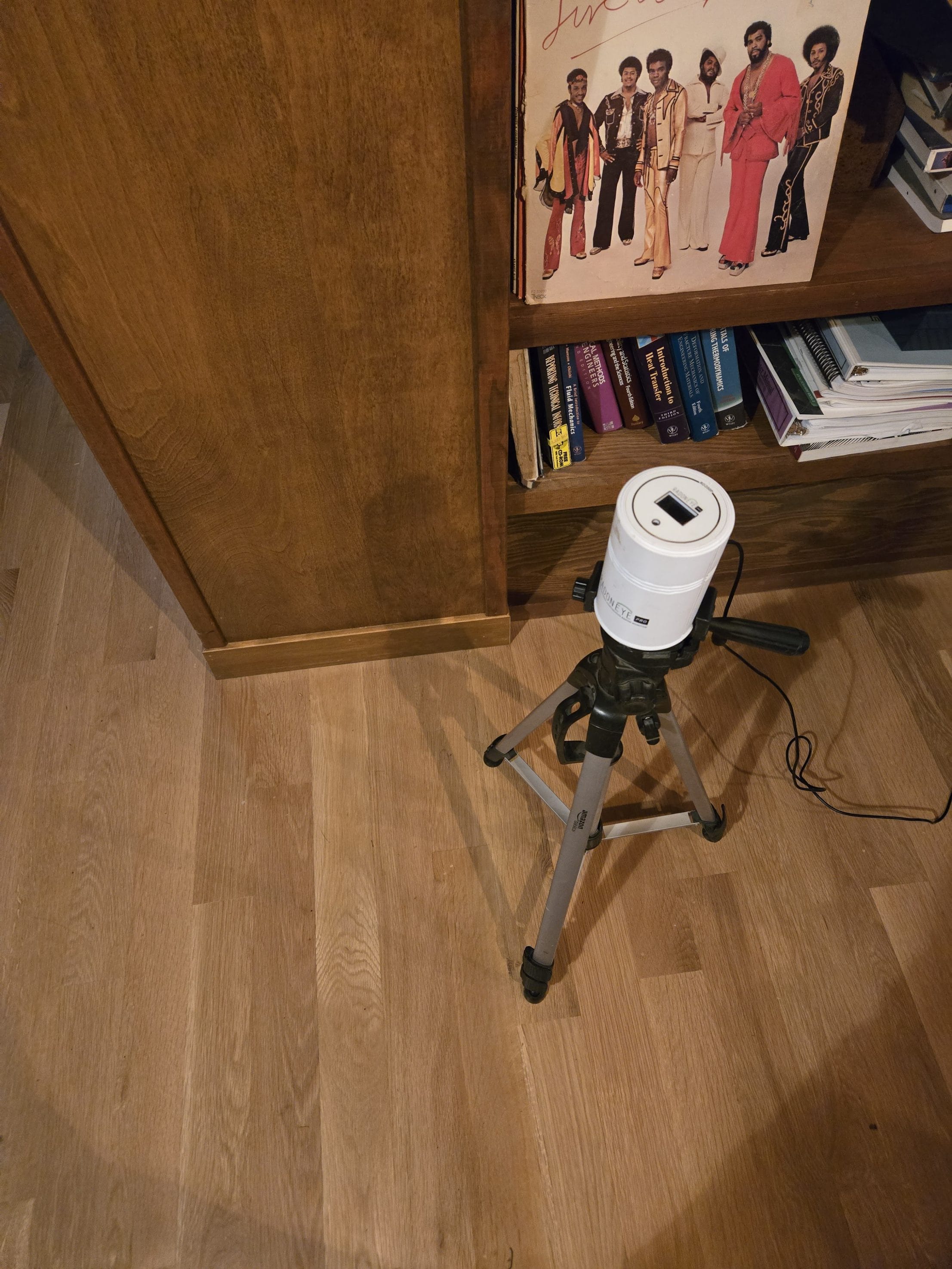 Radon measurement device on tripod in living room
