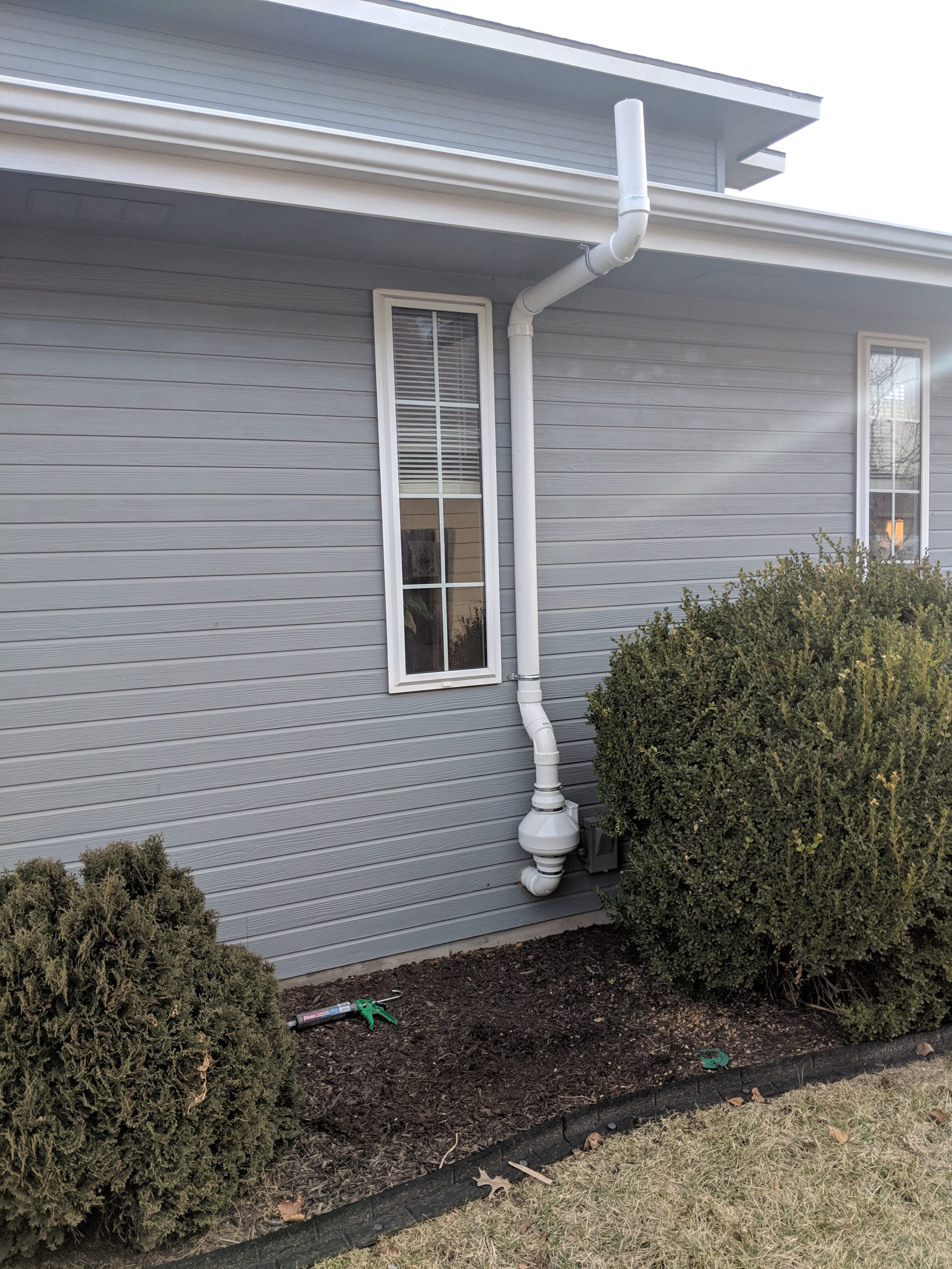 House Exterior with Installed Radon Mitigation System
